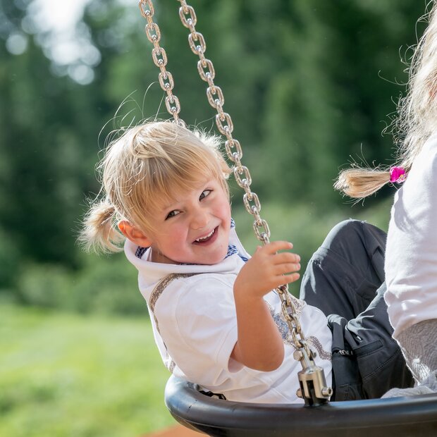 Laughing children on the swings 