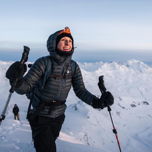 Smiling female ski tourer in the winter high mountains